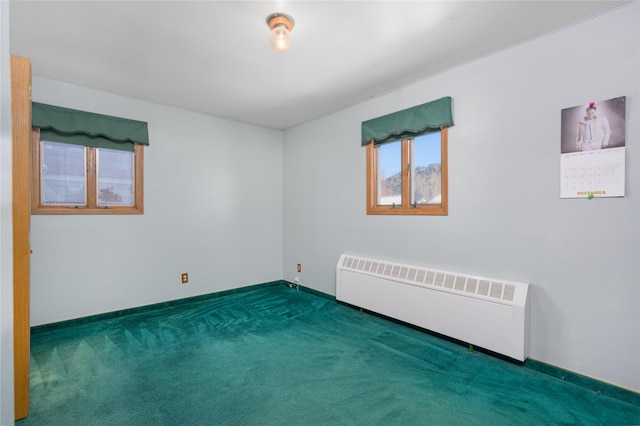 carpeted spare room featuring radiator