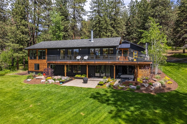 rear view of house featuring a lawn and a patio area