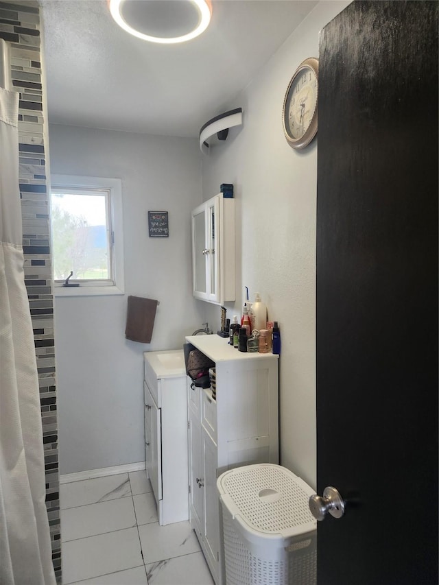 59 N Fork Rd, Townsend, MT 59644 - full bathroom with marble look tiles, vanity, and a shower with shower curtain