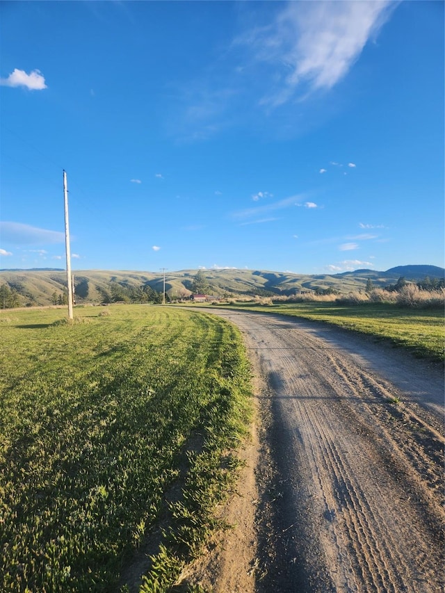 view of road featuring a mountain view and a rural view