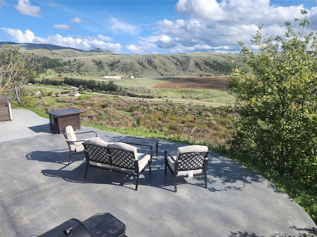 view of patio featuring outdoor lounge area and a mountain view