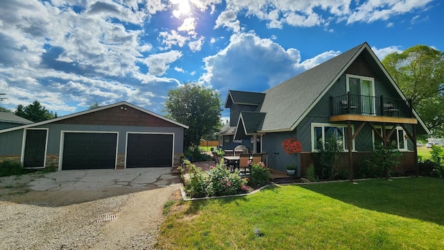 view of home's exterior with a balcony, a garage, and a yard