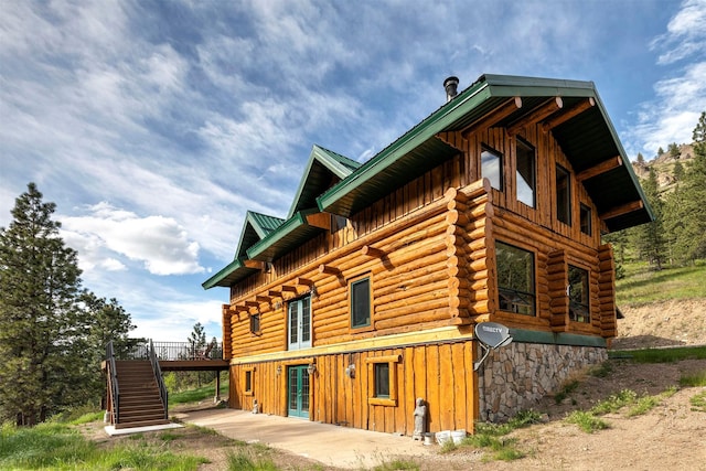 view of property exterior with a wooden deck