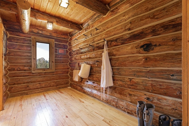 bonus room featuring hardwood / wood-style floors, wood ceiling, rustic walls, and beamed ceiling