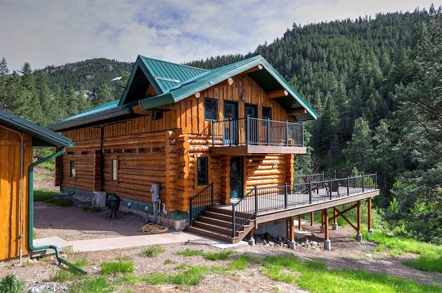 rear view of property with a mountain view