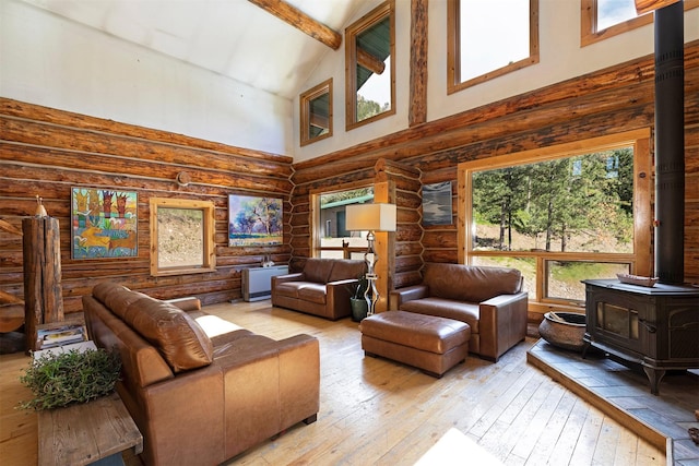 living room featuring light wood-type flooring, log walls, high vaulted ceiling, beamed ceiling, and a wood stove