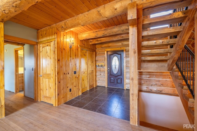 entryway with beamed ceiling, wood ceiling, and dark hardwood / wood-style floors