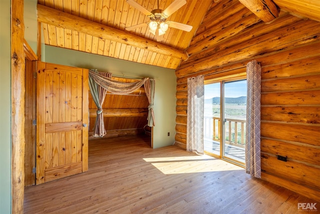 empty room featuring ceiling fan, wooden ceiling, a mountain view, vaulted ceiling with beams, and light hardwood / wood-style floors