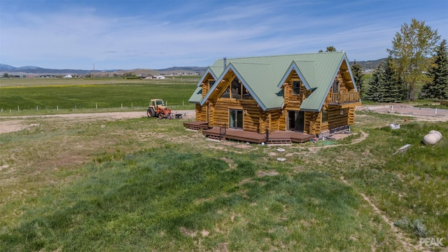 exterior space with a mountain view, a rural view, and a front yard