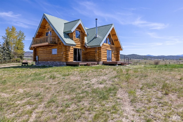 exterior space featuring a mountain view and a balcony