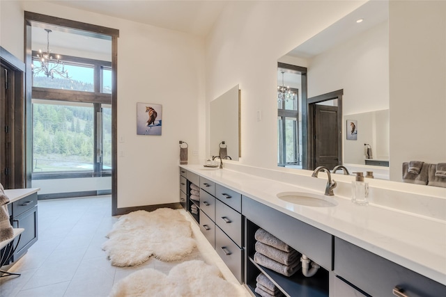 bathroom featuring vanity, tile patterned flooring, and a notable chandelier