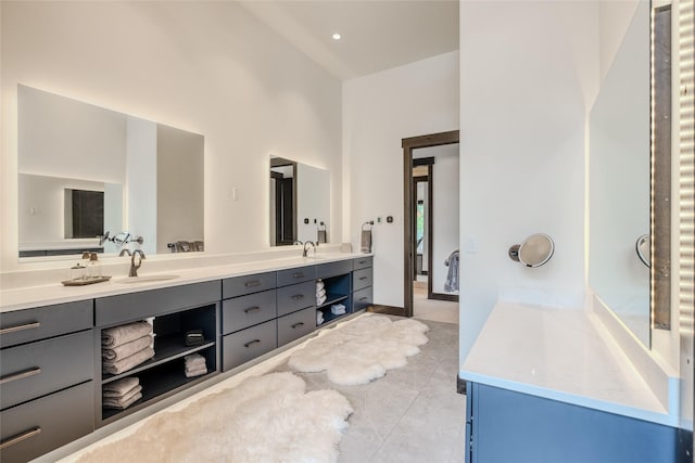 bathroom featuring a towering ceiling and vanity