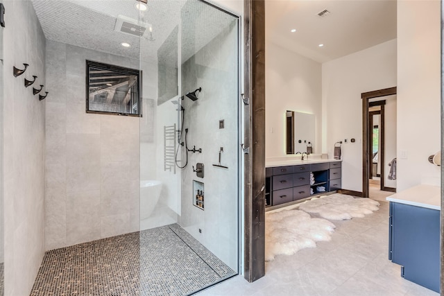 bathroom with separate shower and tub and vanity