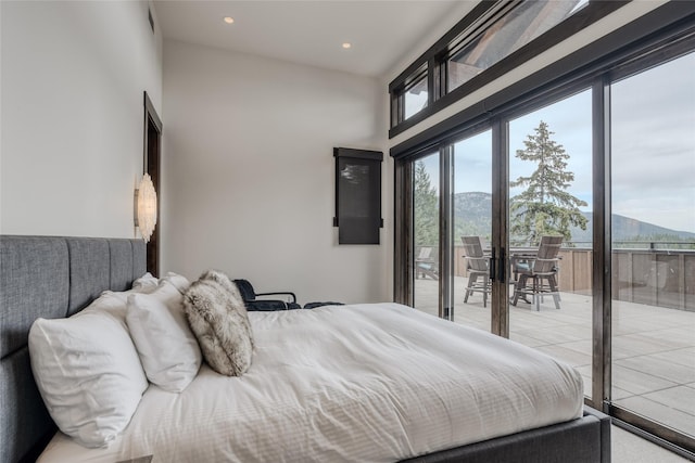 bedroom with access to exterior and a mountain view