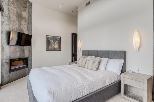 carpeted bedroom featuring a fireplace