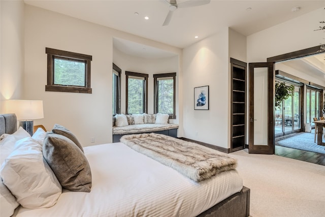 carpeted bedroom featuring ceiling fan, access to exterior, and french doors