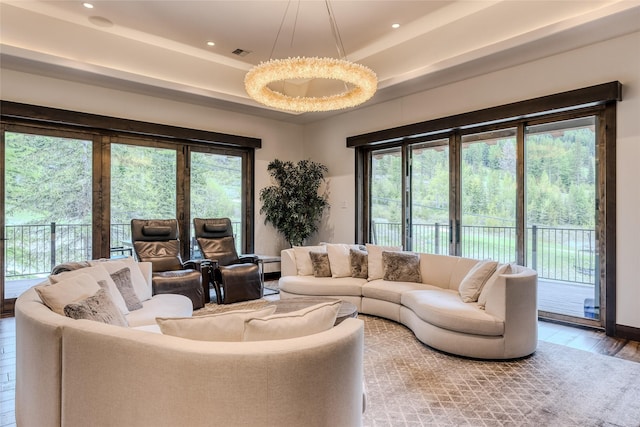 living room with a wealth of natural light and hardwood / wood-style flooring