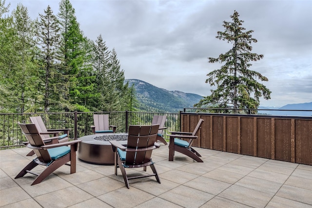 view of patio / terrace featuring a mountain view and an outdoor fire pit