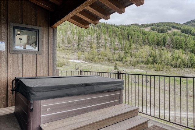 wooden deck featuring a hot tub