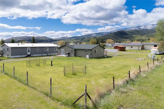 view of yard with a mountain view and a rural view