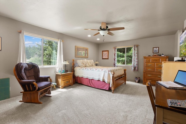 bedroom with light carpet and ceiling fan