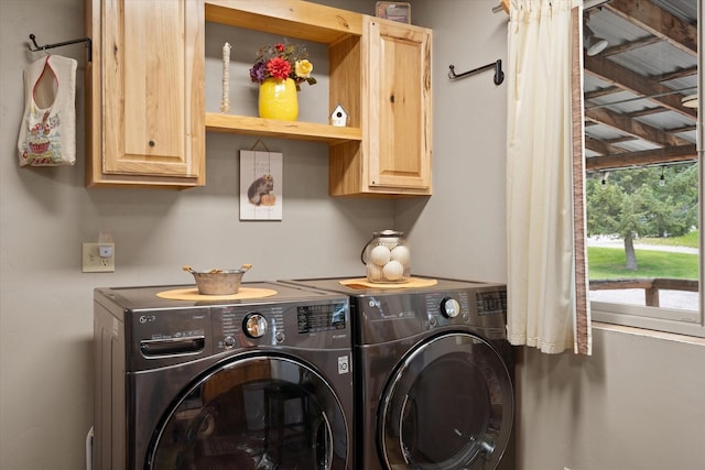 laundry area with cabinets and separate washer and dryer