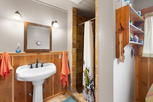 bathroom with wood walls and walk in shower