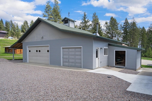 view of front of home with a garage and an outdoor structure