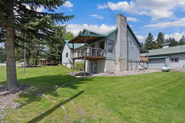 back of house featuring a yard and a deck