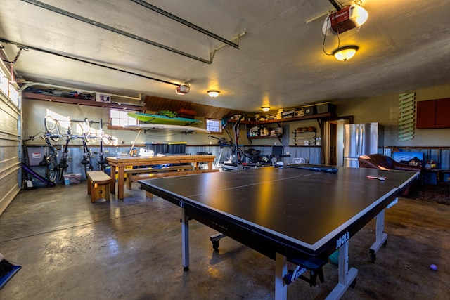 recreation room with a workshop area and concrete floors