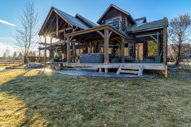 rear view of house featuring a yard