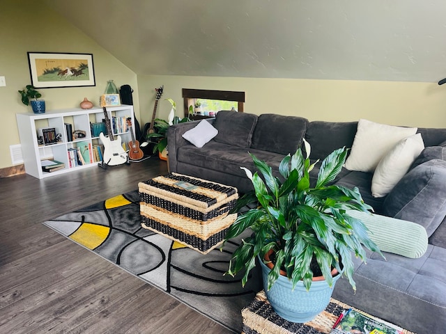 living room featuring dark wood-type flooring and lofted ceiling