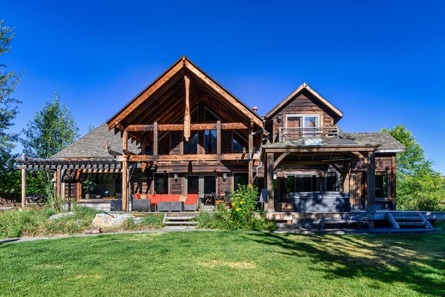 rear view of house featuring a pergola and a yard