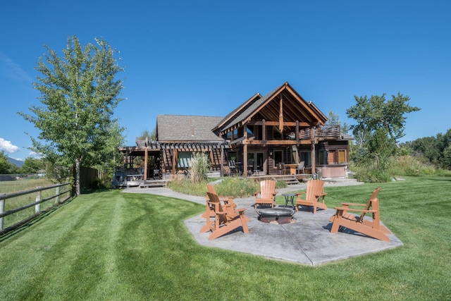 back of property featuring an outdoor fire pit, a patio area, and a yard