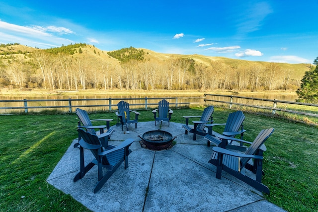 view of patio / terrace with an outdoor fire pit and a mountain view