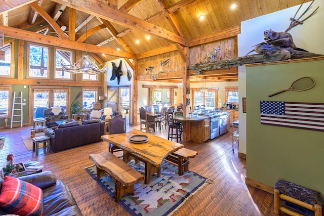 living room featuring high vaulted ceiling, beamed ceiling, hardwood / wood-style flooring, and wooden ceiling