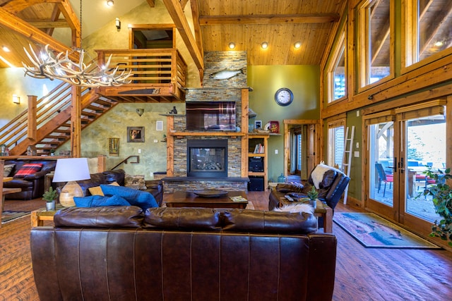 living room featuring a fireplace, a chandelier, beam ceiling, wood-type flooring, and high vaulted ceiling