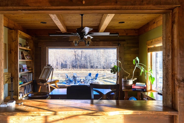 dining area featuring beam ceiling, wood ceiling, and ceiling fan