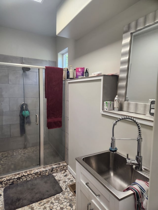 bathroom featuring tile patterned floors, vanity, and walk in shower