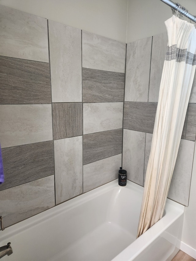 bathroom with shower / bath combo with shower curtain