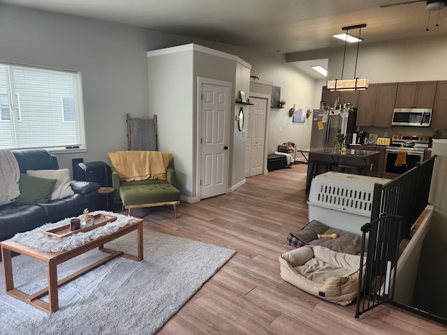 living room featuring light hardwood / wood-style floors and ceiling fan