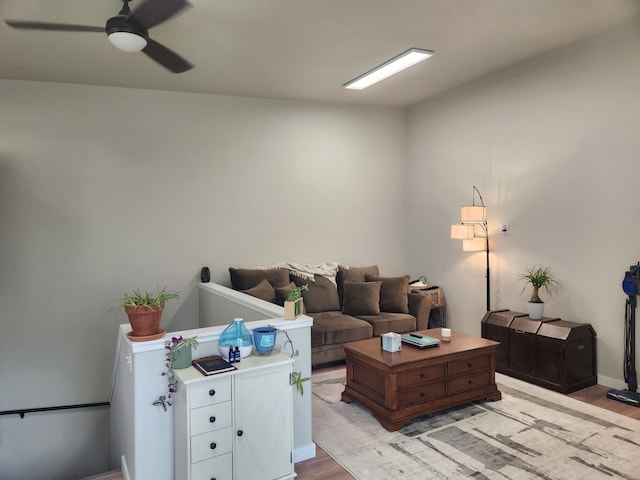 living room featuring ceiling fan and light hardwood / wood-style flooring