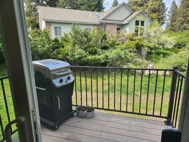 deck with a lawn and area for grilling