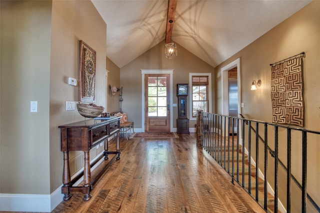 entrance foyer featuring hardwood / wood-style flooring, lofted ceiling, and a chandelier