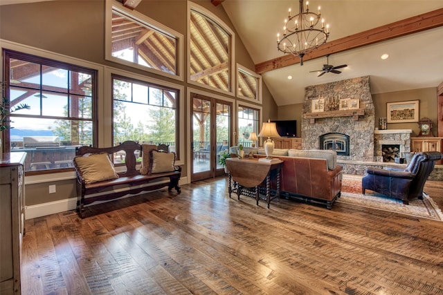 living room with wood-type flooring, a stone fireplace, high vaulted ceiling, and a wealth of natural light