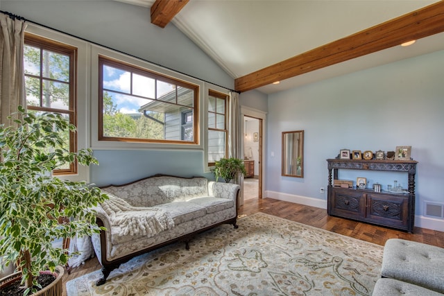 living area featuring wood-type flooring, vaulted ceiling with beams, and a wealth of natural light