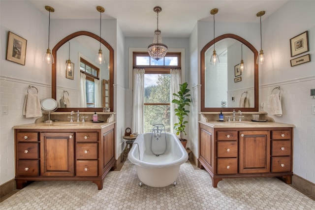 bathroom featuring a bathing tub, tile walls, and vanity