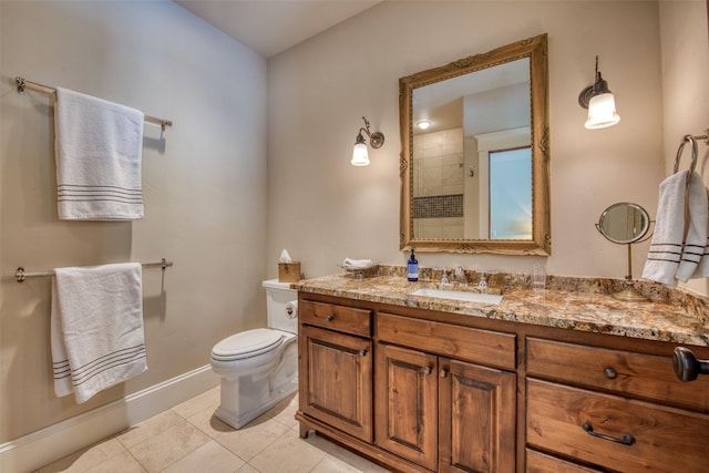 bathroom featuring vanity, tile patterned floors, and toilet