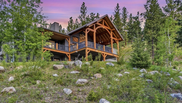 view of back house at dusk