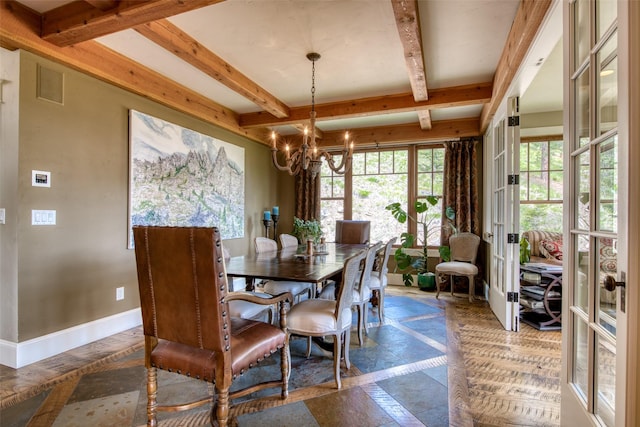 dining area with a notable chandelier, beam ceiling, and french doors